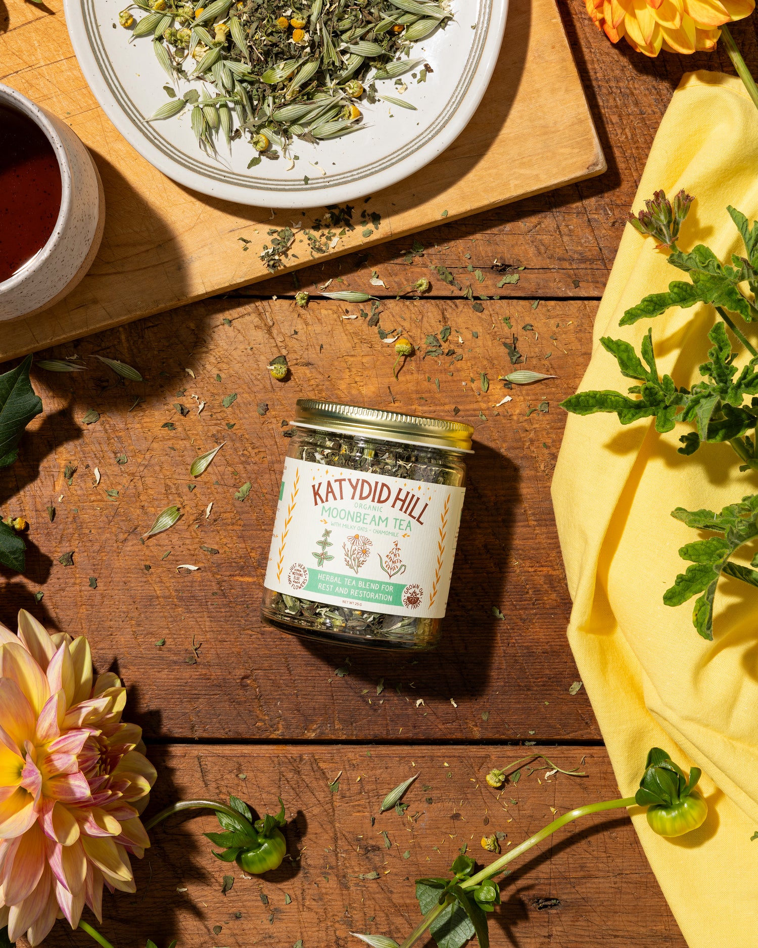 jar of moonbeam tea on wood background with loose herbs in a bowl