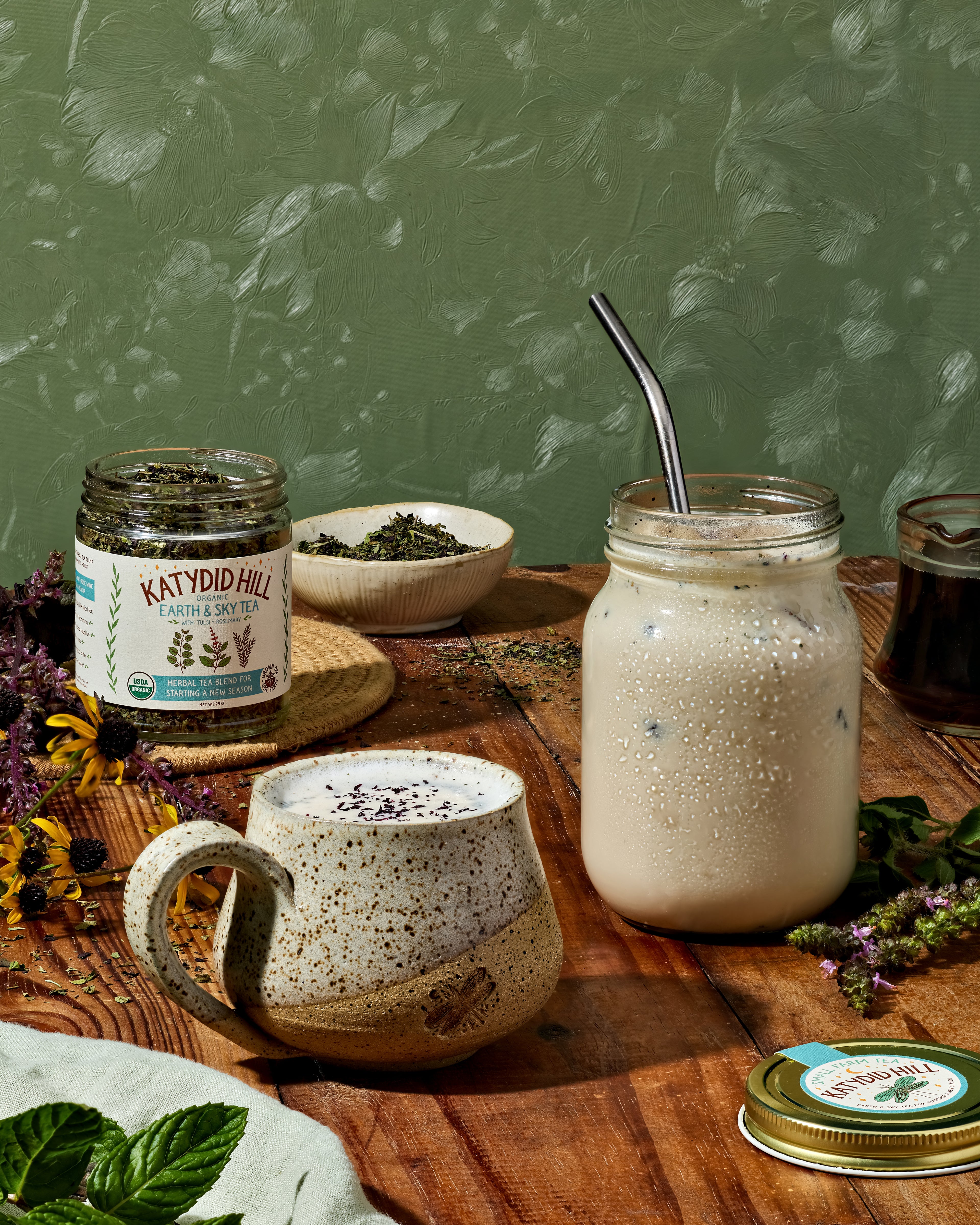 Organic Earth & Sky herbal tea with tulsi and rosemary in a glass jar. Loose leaf herbal tea blend for starting a new season.