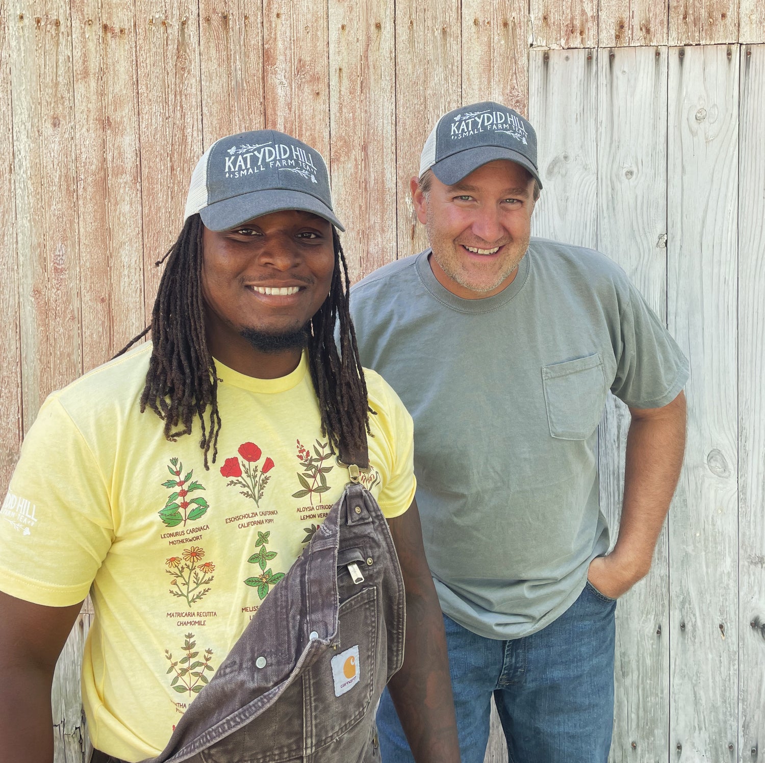 two people wearing katydid hill small farm tea caps