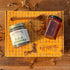 Herbal tea jar, honey jar, and honey stick on top of a gift box