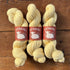 Three skeins of light yellow yarn with &