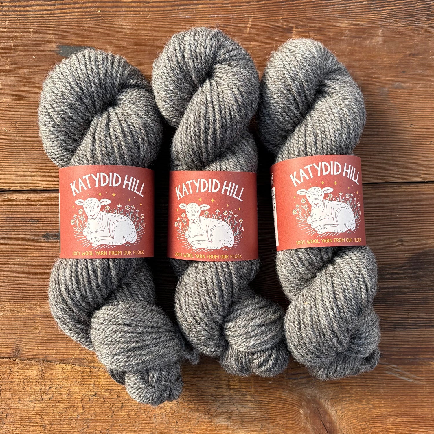 Grey yarn on a wood background.