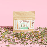 moonbeam tea sample pack with loose herbs on pink background