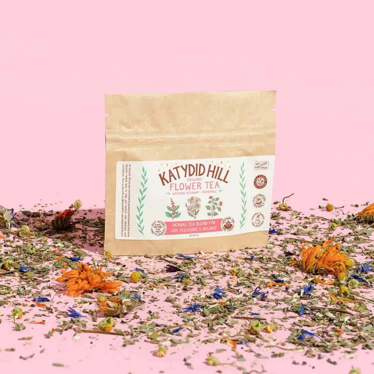 flower tea sample pack with loose herbs on pink background