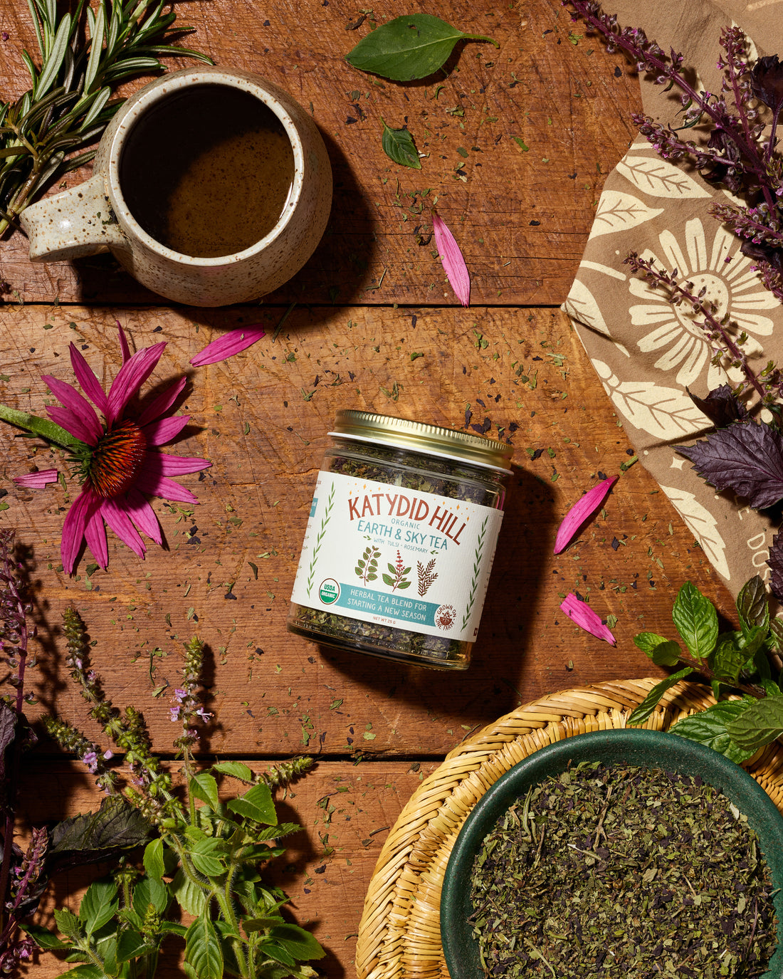 Organic Earth &amp; Sky herbal tea with tulsi and rosemary in a glass jar. Loose leaf herbal tea blend for starting a new season.