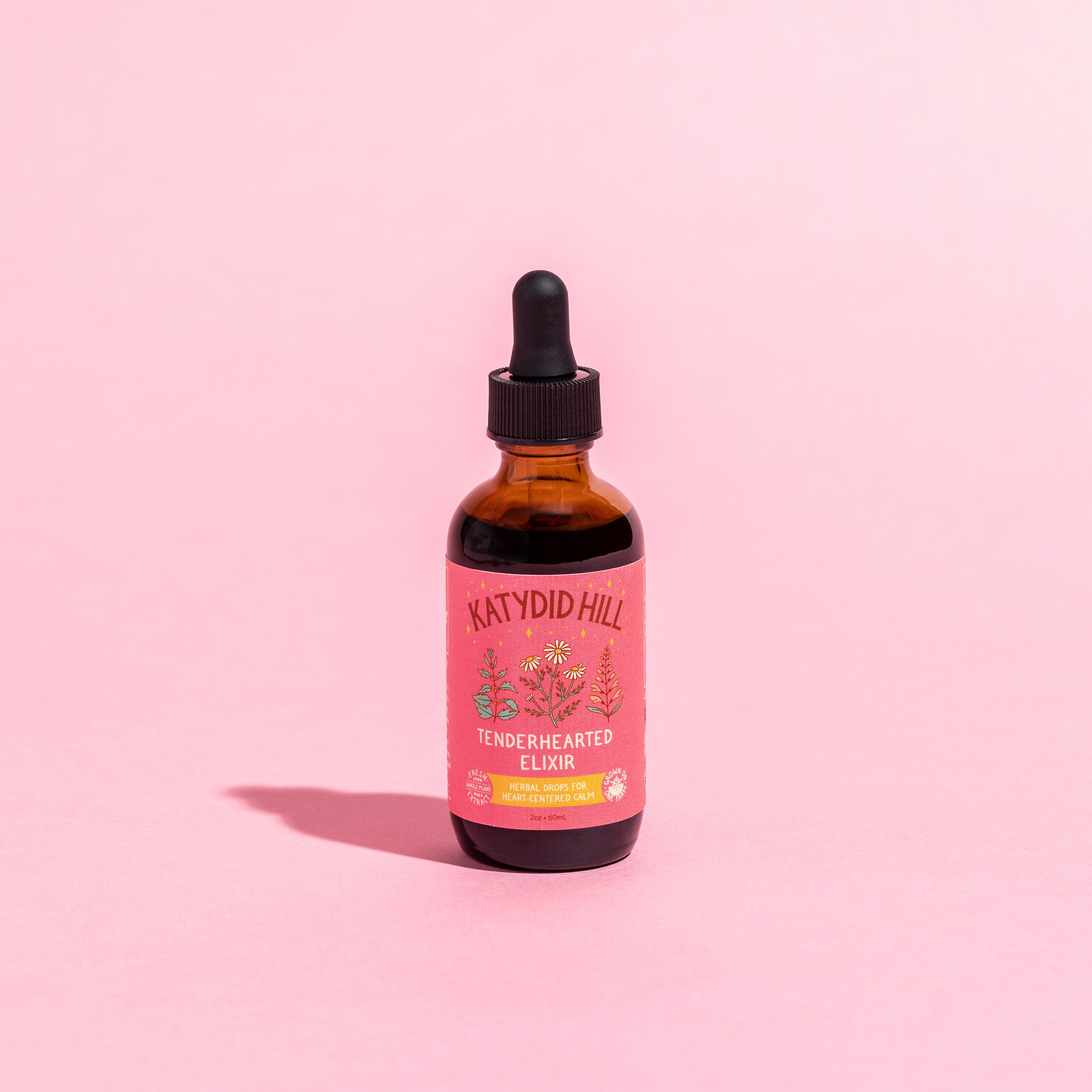 closed bottle of tenderhearted elixir on pink background