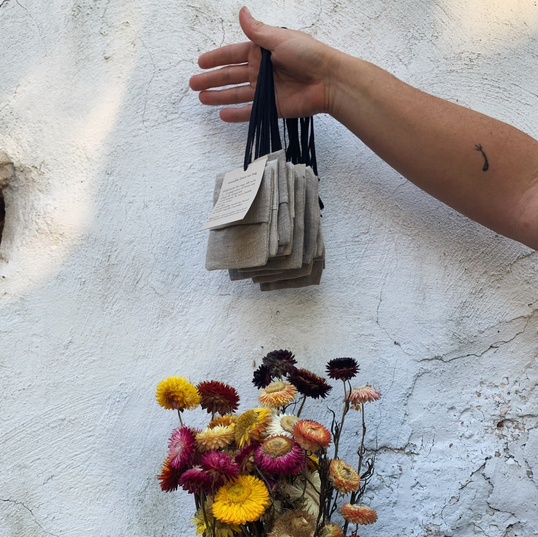 hand holding linen tea bags