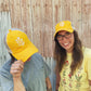 two people wearing katydid hill chamomile cap