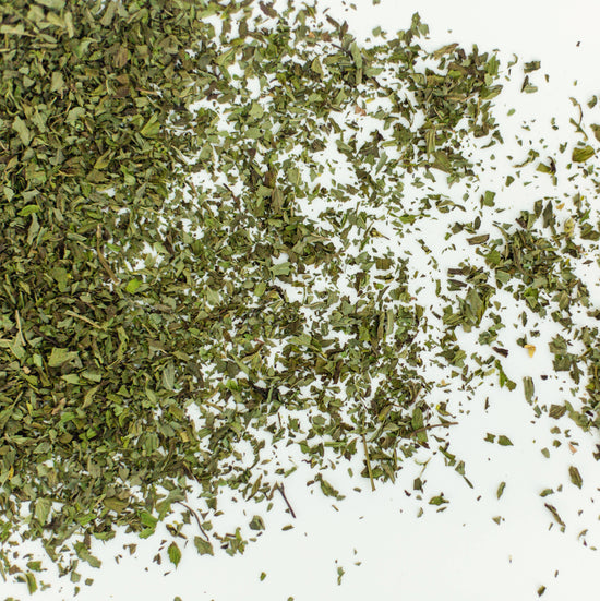 Peppermint loose leaf herbal tea leaves on white background