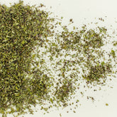 Tulsi (Holy Basil) loose leaf herbal tea leaves on white background
